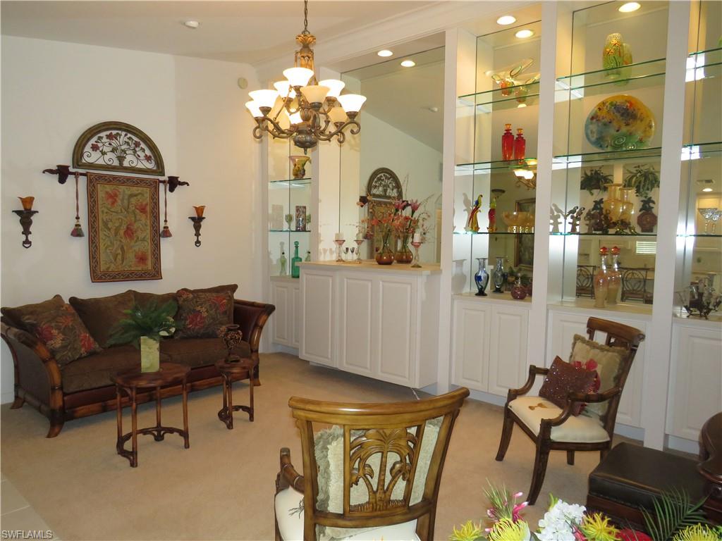 3732 Exuma Way Naples, FL 34119 - Photo 4 of 24 a living room with furniture and a chandelier