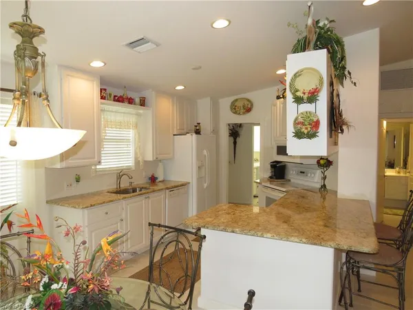 a kitchen with stainless steel appliances granite countertop a sink and cabinets