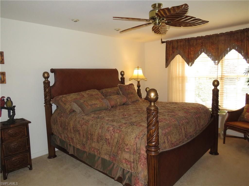 3732 Exuma Way Naples, FL 34119 - Photo 9 of 24 a bed sitting in a bedroom next to a window