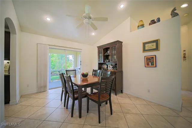 a view of a dining room with furniture and a chandelier