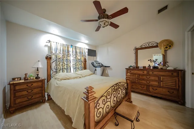 a bedroom with a bed and a dresser in it