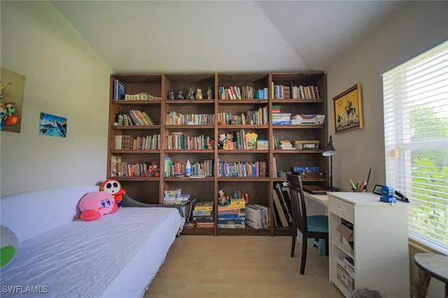a bedroom with furniture and a book shelf