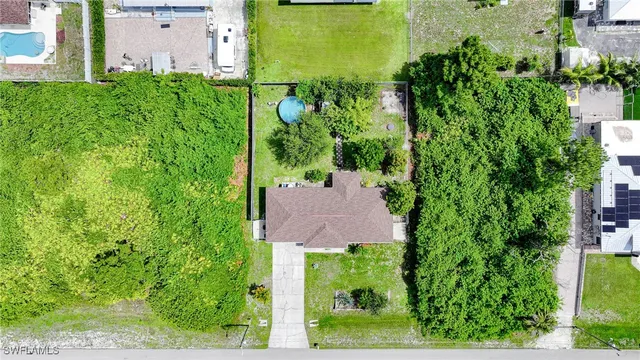 an aerial view of a house with a garden and yard