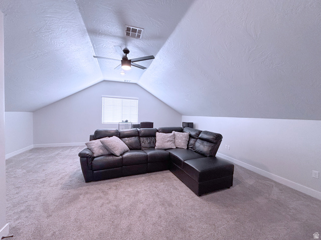 429 East Treasure Road Washington, UT 84780 - Photo 21 of 36 Living room featuring a textured ceiling, light carpet, and ceiling fan