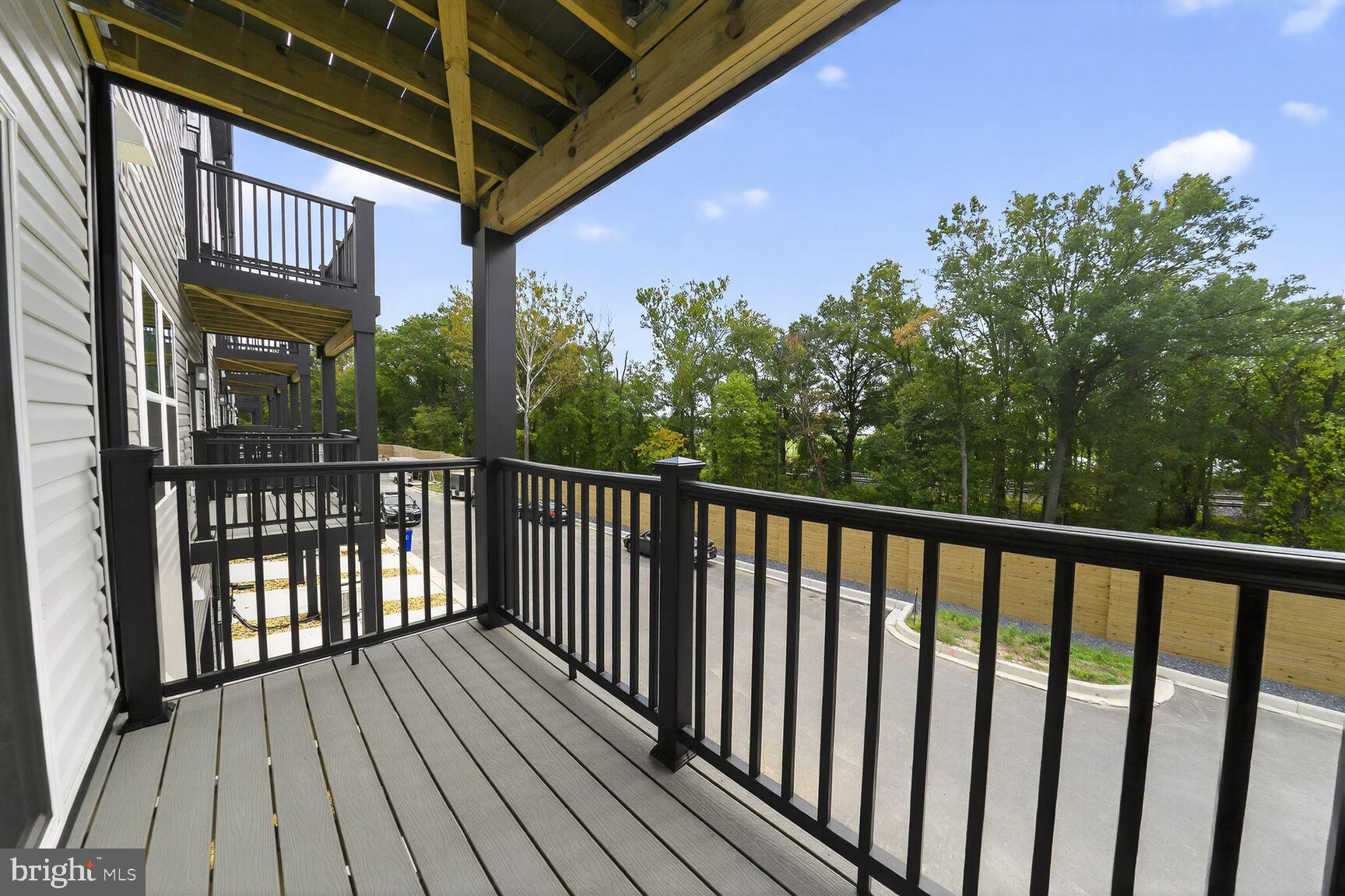 9990 A Justify Run Laurel, MD 20723 - Photo 14 of 28 a view of a balcony with wooden floor