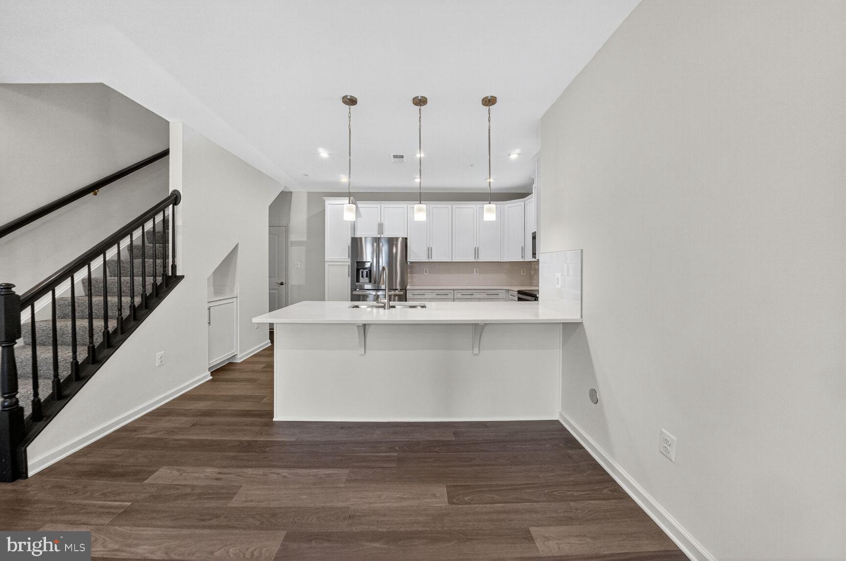 9990 A Justify Run Laurel, MD 20723 - Photo 2 of 28 a view of kitchen with wooden floor and electronic appliances