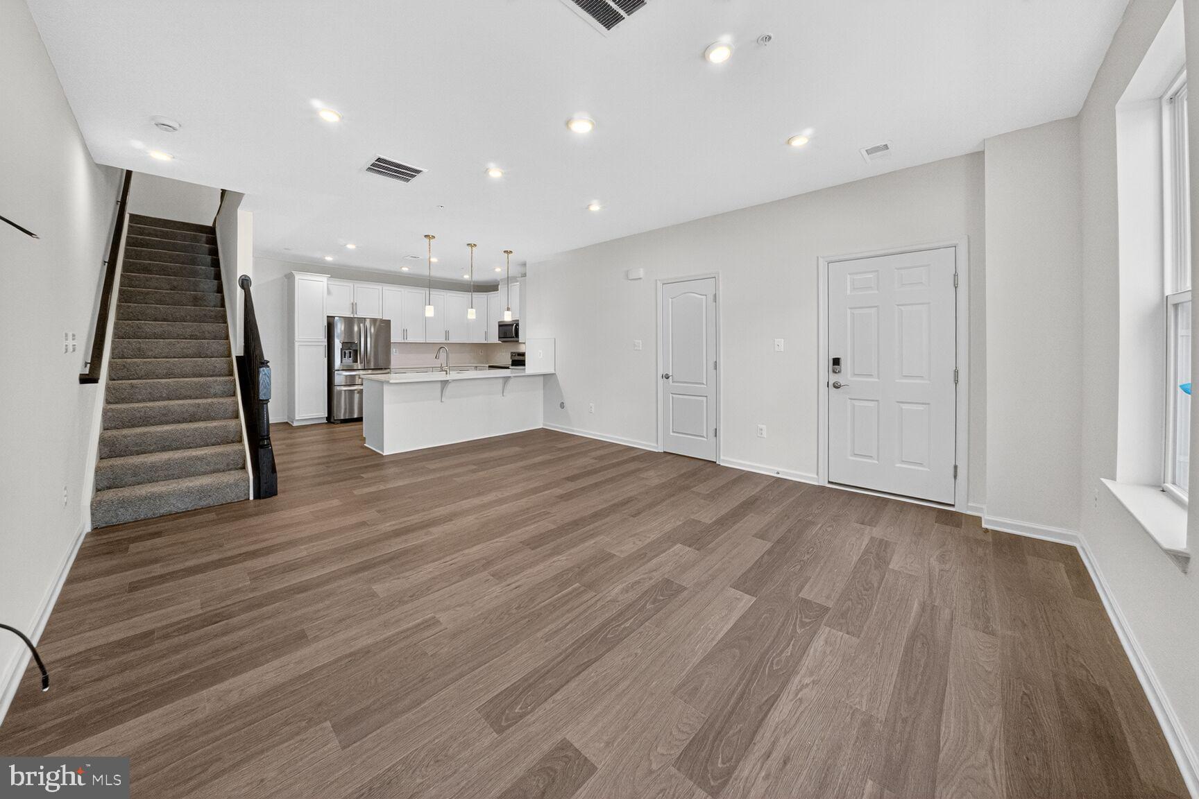 9990 A Justify Run Laurel, MD 20723 - Photo 4 of 28 a view of a kitchen with wooden floor and electronic appliances
