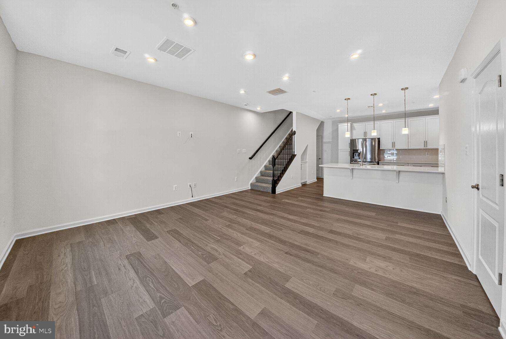 9990 A Justify Run Laurel, MD 20723 - Photo 5 of 28 a view of a kitchen with wooden floor and a sink