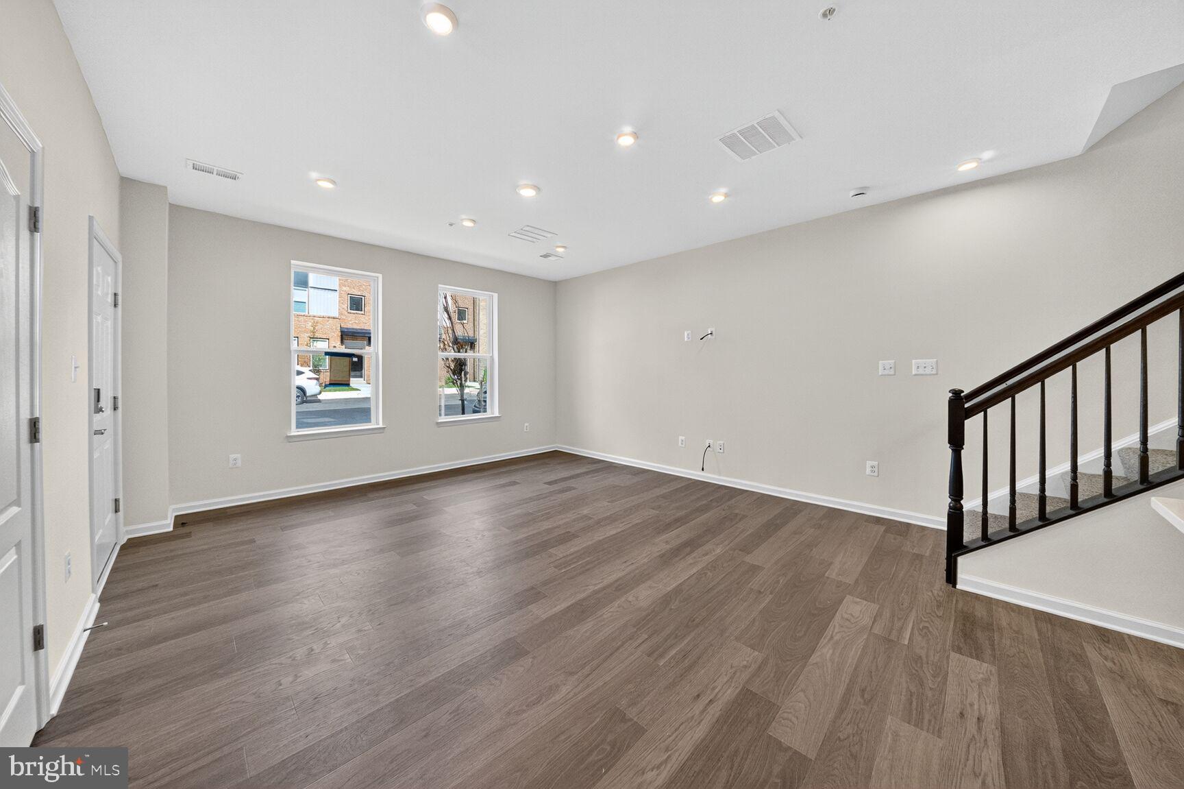 9990 A Justify Run Laurel, MD 20723 - Photo 6 of 28 a view of an empty room with wooden floor and a window