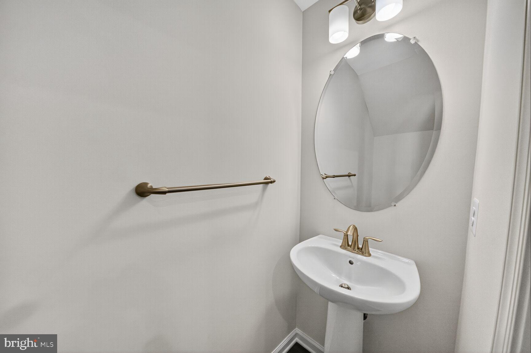 9990 A Justify Run Laurel, MD 20723 - Photo 7 of 28 a bathroom with a sink a mirror and vanity