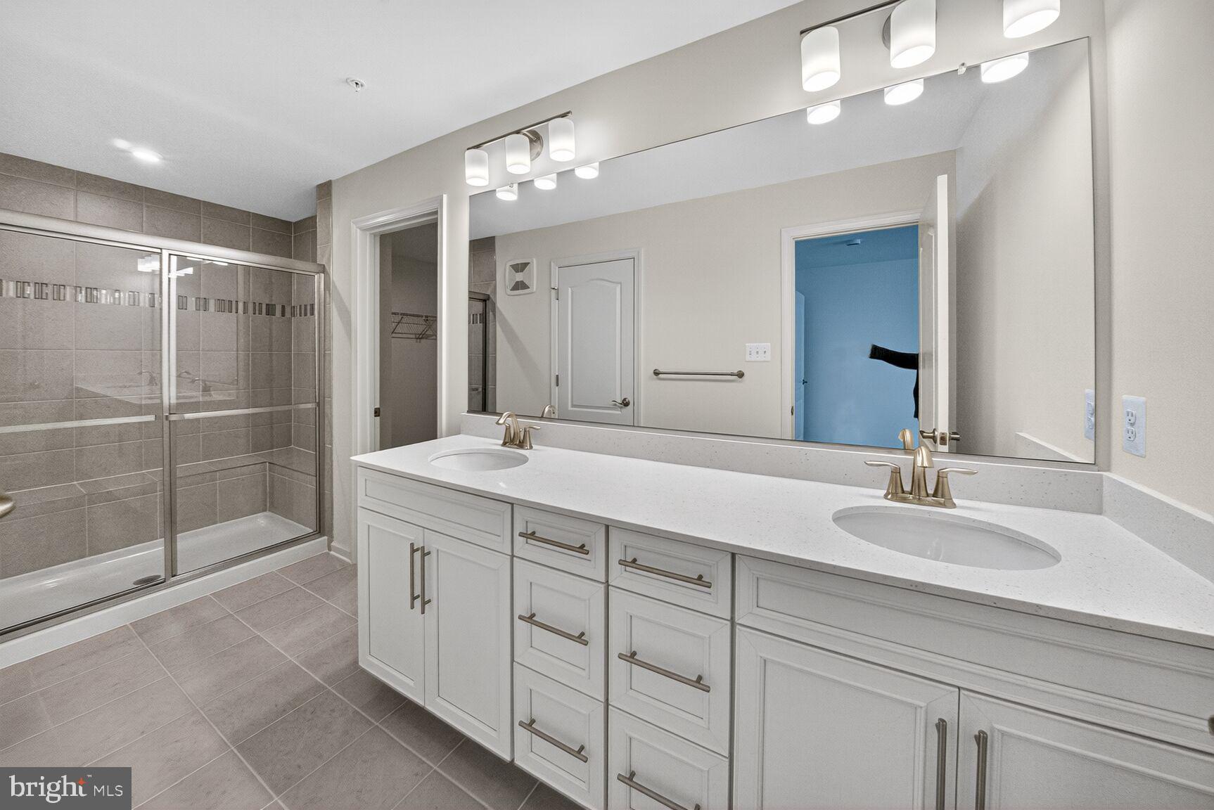 9990 A Justify Run Laurel, MD 20723 - Photo 8 of 28 a bathroom with a double vanity sink and a mirror