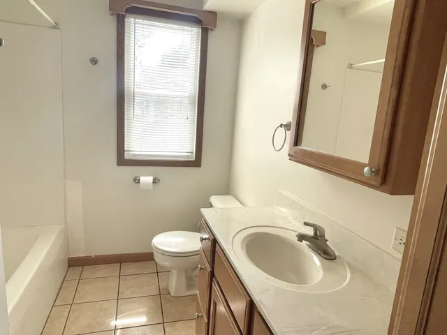 a bathroom with a sink toilet and a mirror