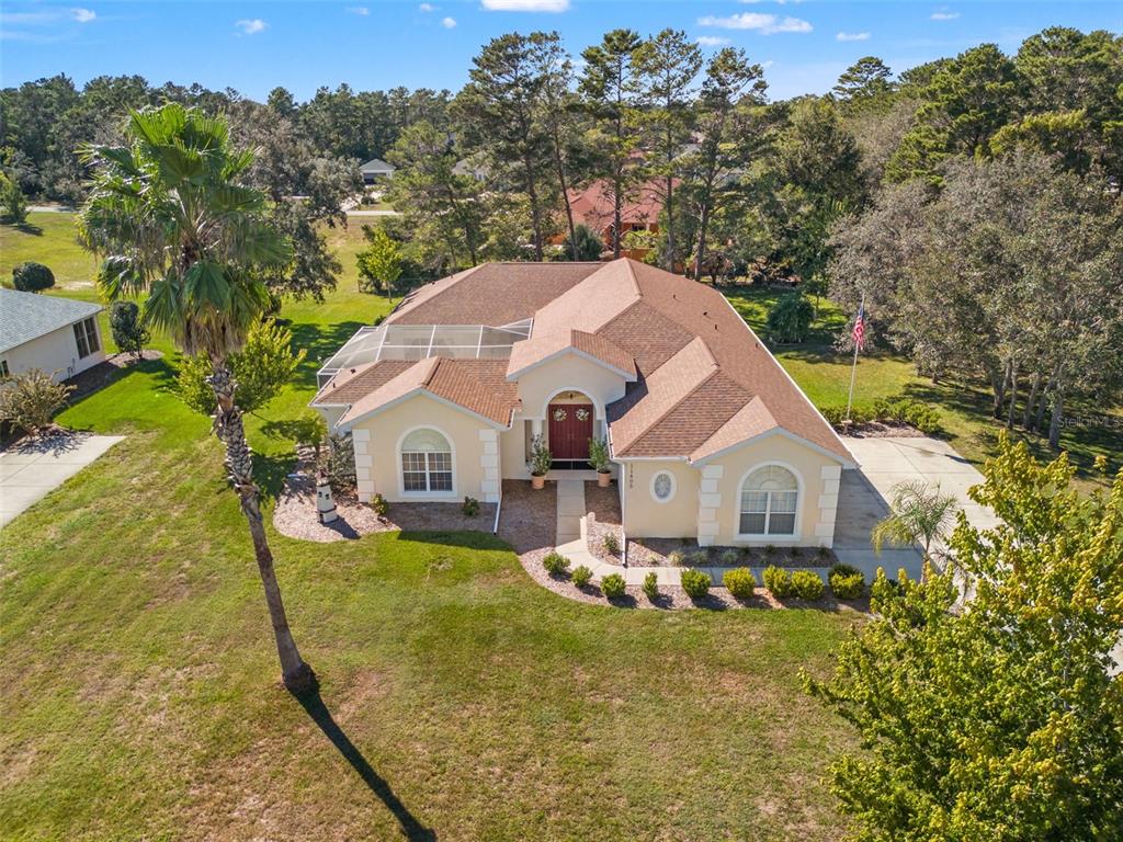 11405 Warm Wind Way Weeki Wachee, FL 34613 - Photo 2 of 46 a view of a house with a yard