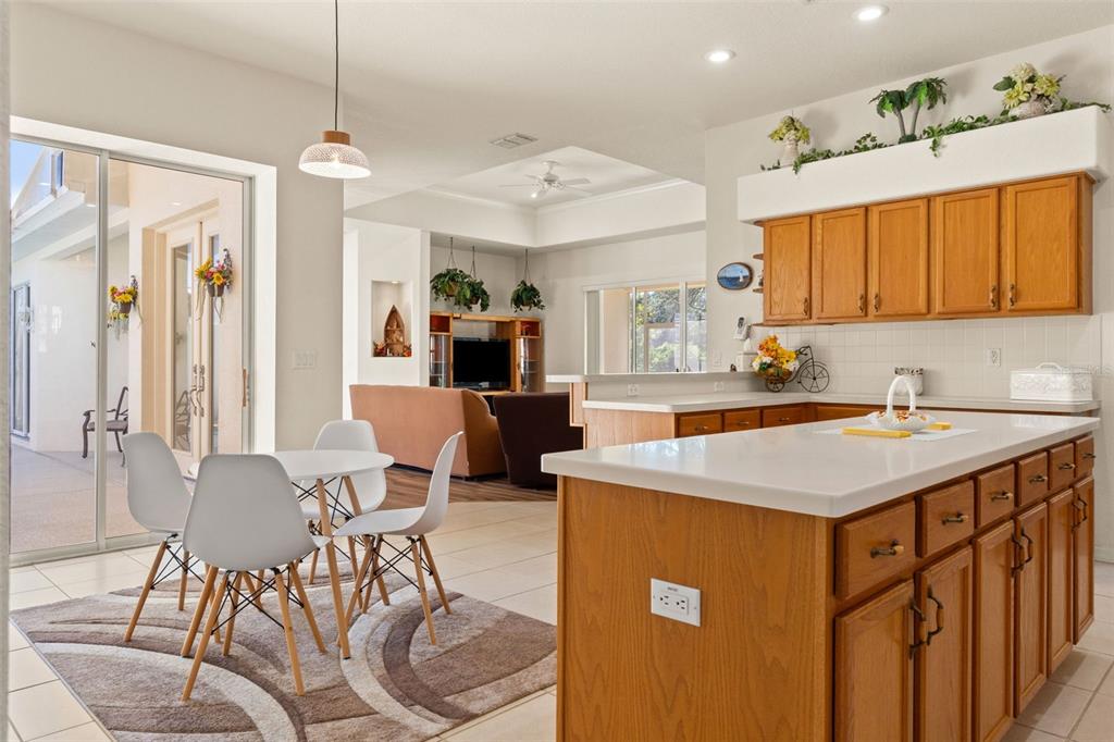11405 Warm Wind Way Weeki Wachee, FL 34613 - Photo 21 of 46 a kitchen that has a table chairs in it and wooden floors