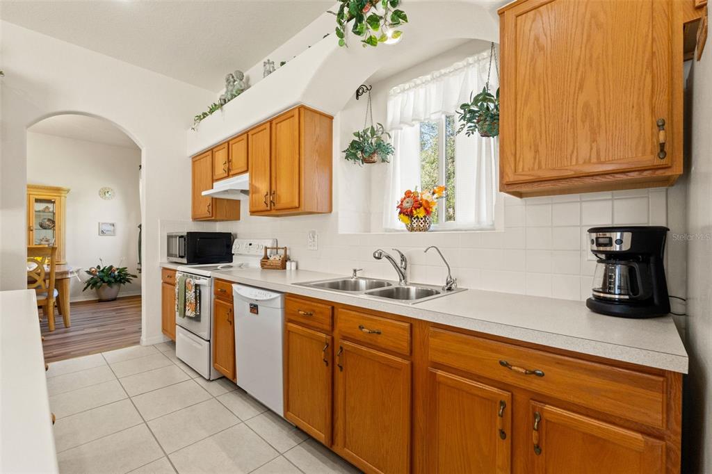 11405 Warm Wind Way Weeki Wachee, FL 34613 - Photo 24 of 46 a kitchen with stainless steel appliances granite countertop a sink and cabinets
