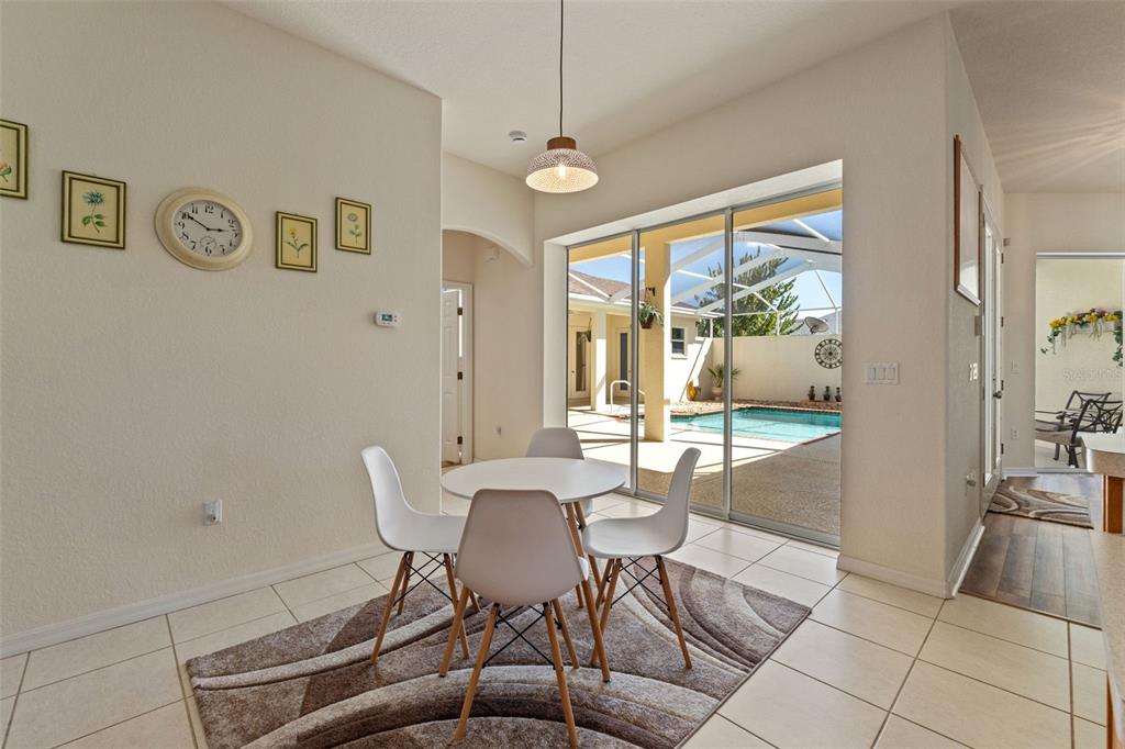 11405 Warm Wind Way Weeki Wachee, FL 34613 - Photo 25 of 46 a dining room with furniture and a large window