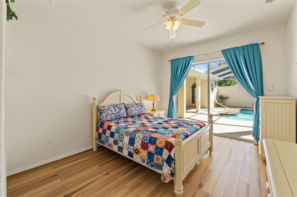 11405 Warm Wind Way Weeki Wachee, FL 34613 - Photo 32 of 46 a bedroom with a bed next to a window with outer view