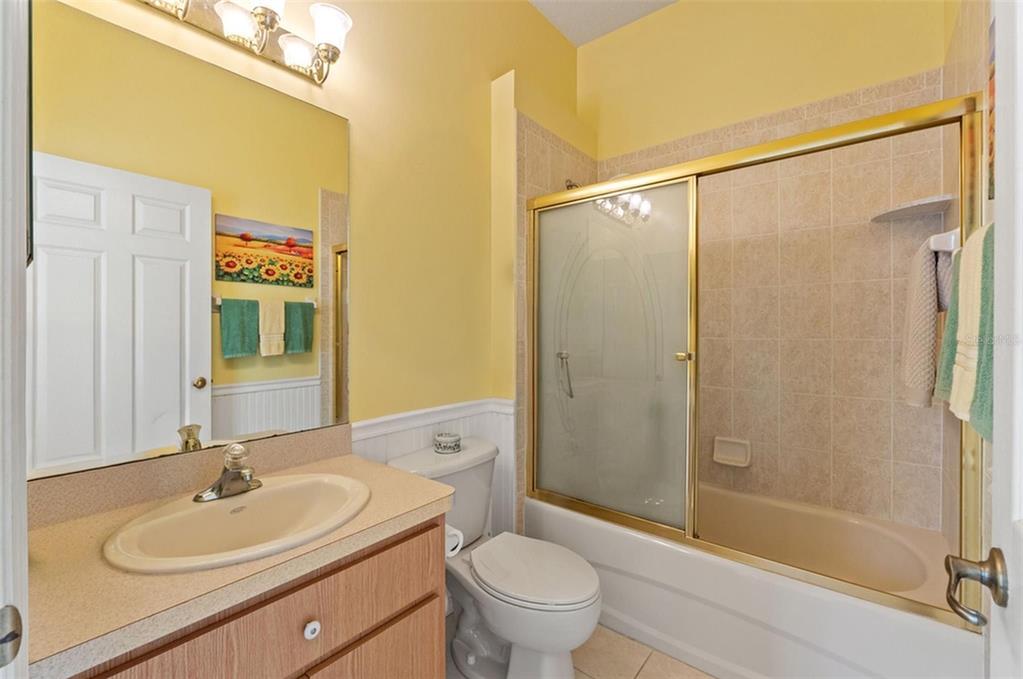 11405 Warm Wind Way Weeki Wachee, FL 34613 - Photo 33 of 46 a bathroom with a sink a toilet and shower