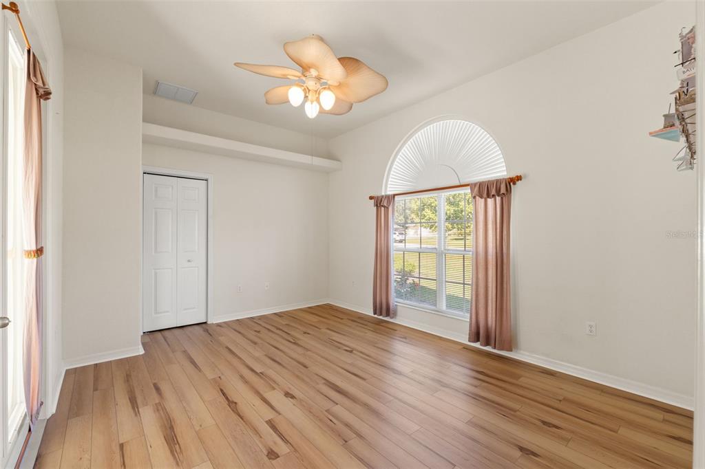 11405 Warm Wind Way Weeki Wachee, FL 34613 - Photo 36 of 46 wooden floor in an empty room with a window