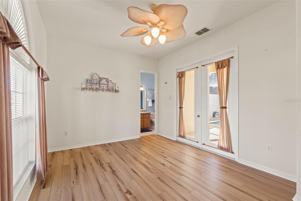 11405 Warm Wind Way Weeki Wachee, FL 34613 - Photo 37 of 46 a view of empty room with wooden floor and fan