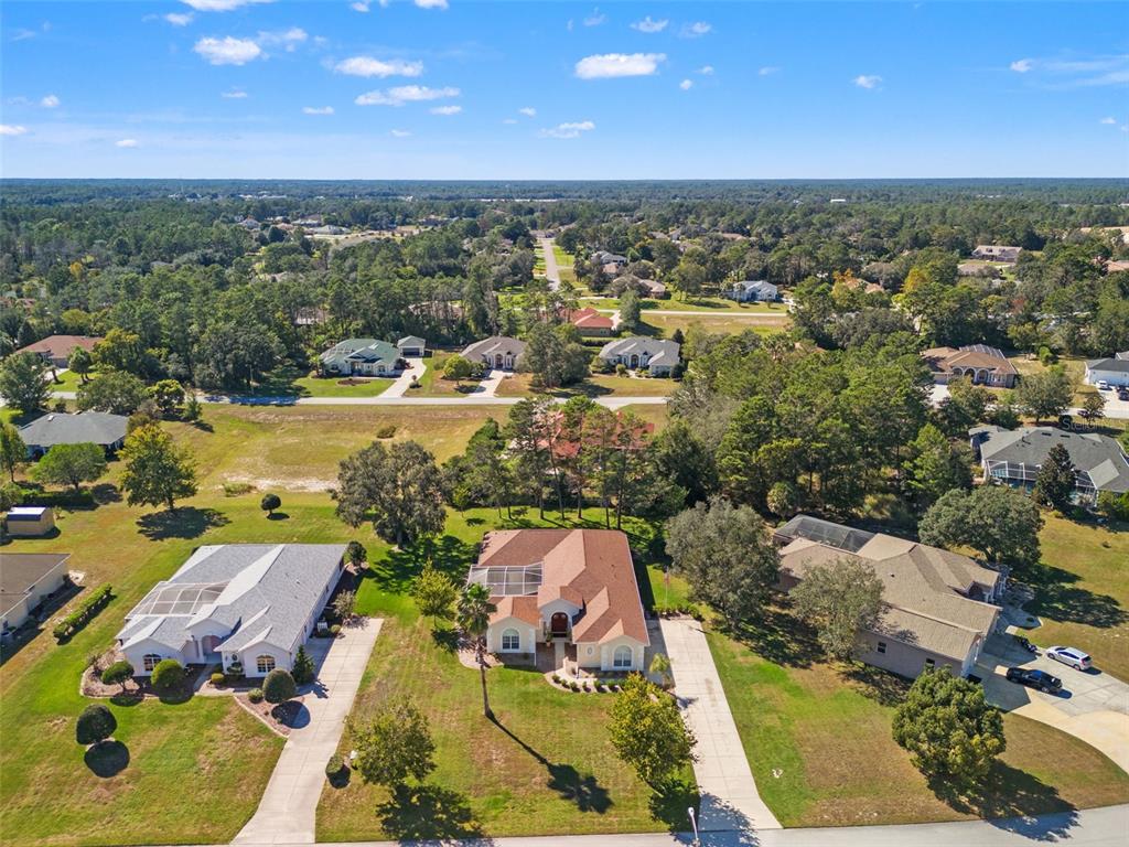 11405 Warm Wind Way Weeki Wachee, FL 34613 - Photo 4 of 46 an aerial view of a house with a swimming pool yard and outdoor seating