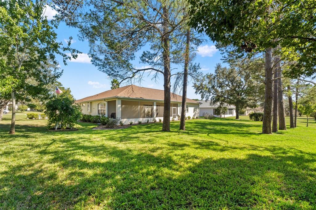 11405 Warm Wind Way Weeki Wachee, FL 34613 - Photo 45 of 46 a yellow house in middle of the forest