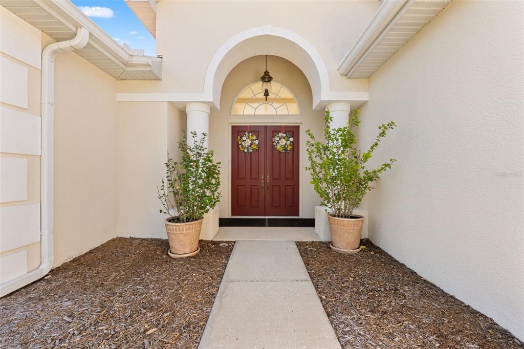 11405 Warm Wind Way Weeki Wachee, FL 34613 - Photo 5 of 46 a view of a hallway with potted plants