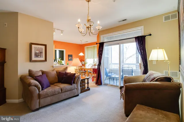a view of a room with furniture and wooden floor