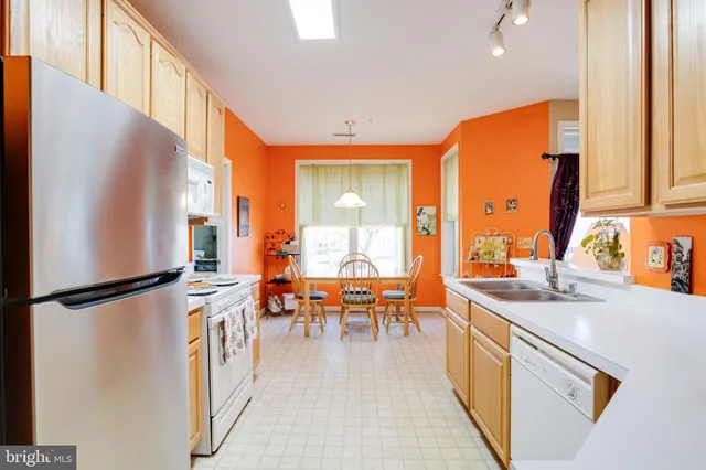 a kitchen that has a lot of cabinets and refrigerator