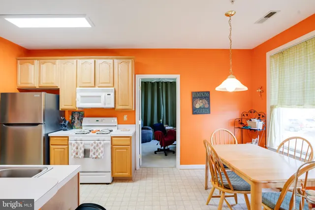 a kitchen with refrigerator a stove a washer and dryer