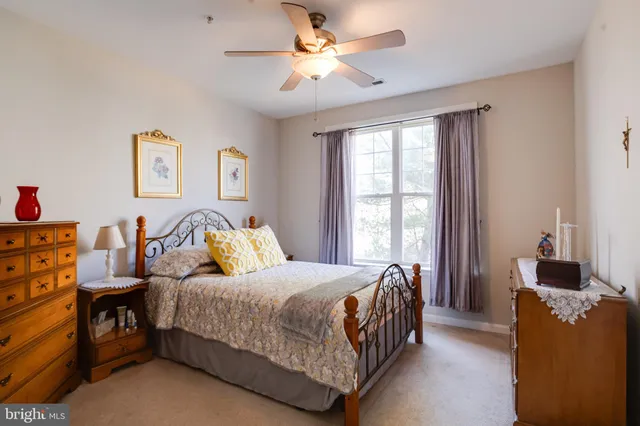 a dining room with furniture a chandelier and wooden floor