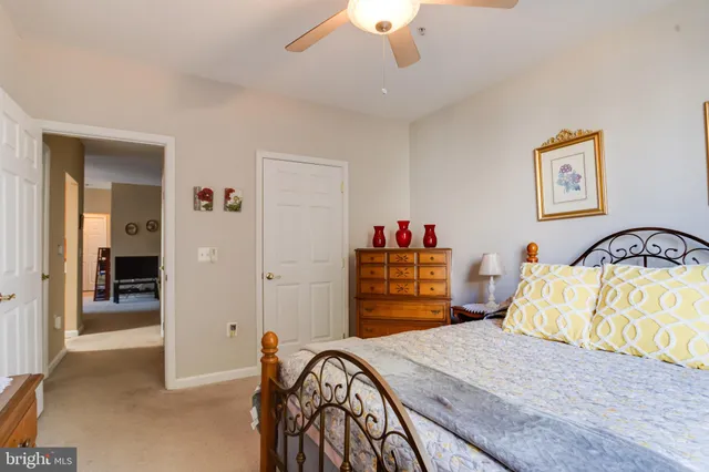 a bedroom with a bed and a dresser with mirror