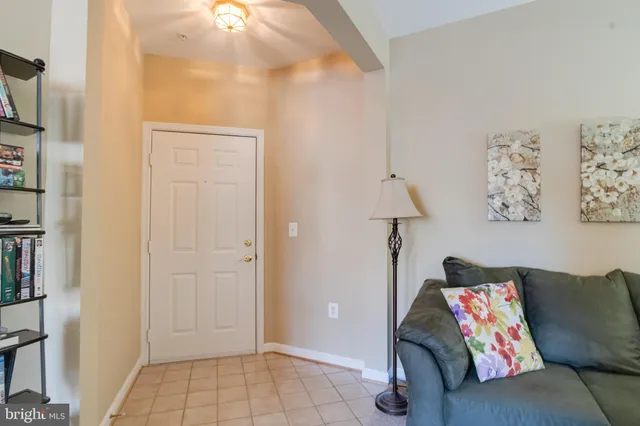 a living room with furniture and a lamp