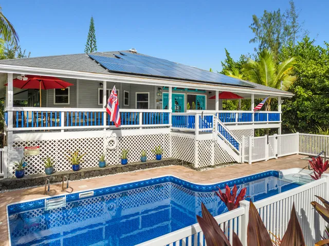 a view of house with a large window and wooden fence