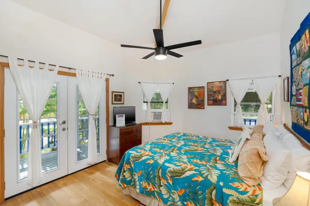 a bedroom with a bed and a wooden floor