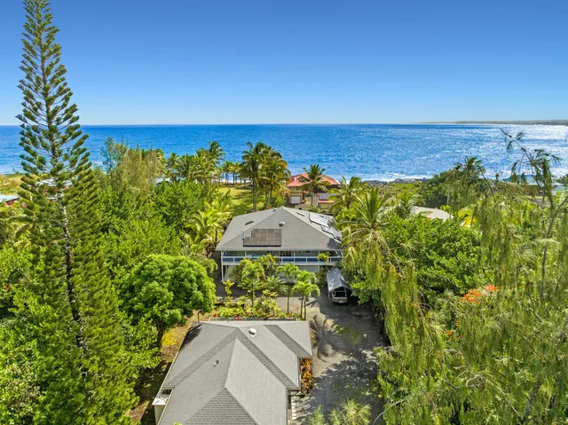 an aerial view of a house with a yard swimming pool outdoor seating and yard