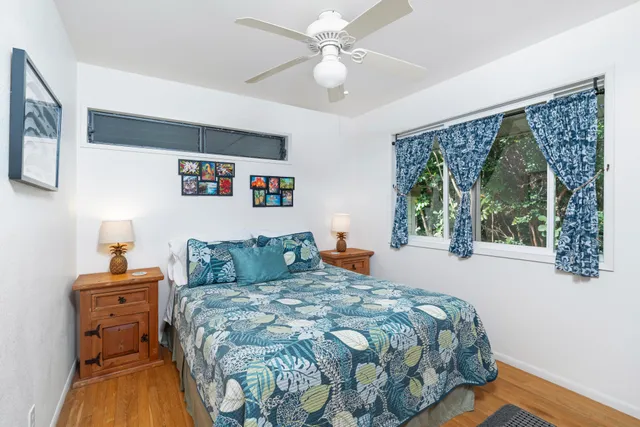 a bedroom with a bed dresser and a window