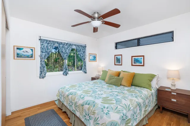 a bedroom with a bed and a painting on the wall