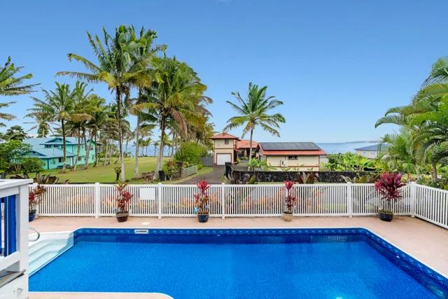 a view of a house with a swimming pool and sitting area
