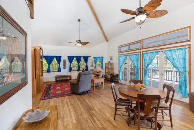 a dining room with furniture window and wooden floor