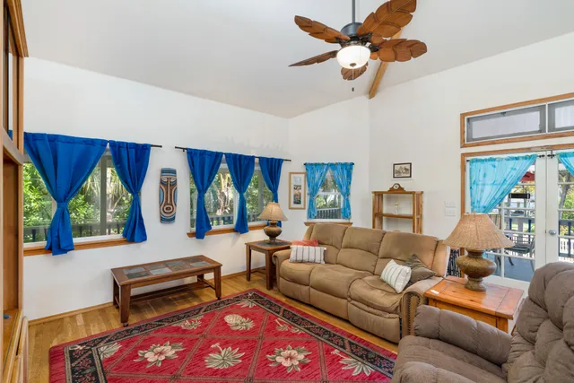 a living room with furniture a window and a flat screen tv