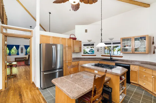 a kitchen with a sink a counter and chairs
