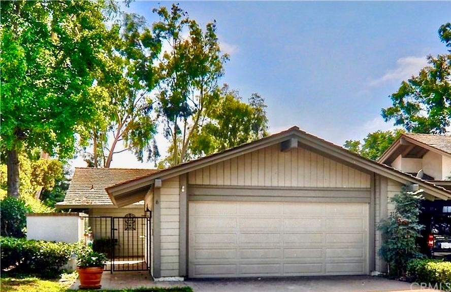 a front view of house with a garden