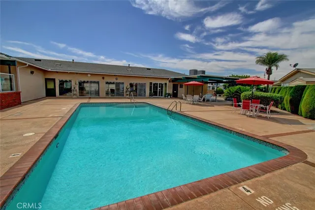 a dining room with furniture and a floor to ceiling window