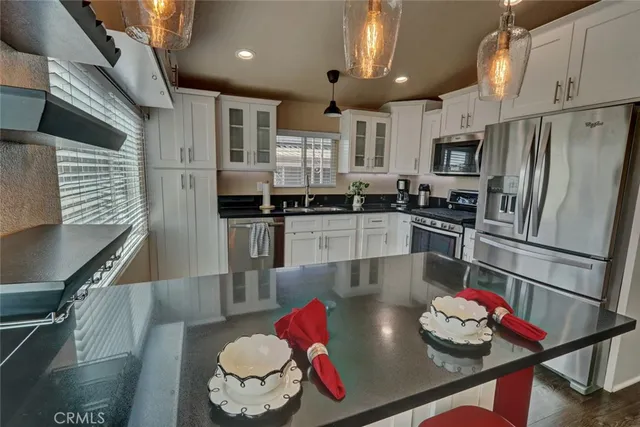 a kitchen with stainless steel appliances cabinets and a table