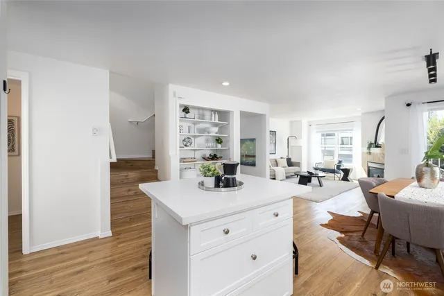 a kitchen with a sink cabinets and wooden floor