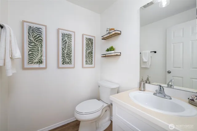 a bathroom with a toilet sink and mirror