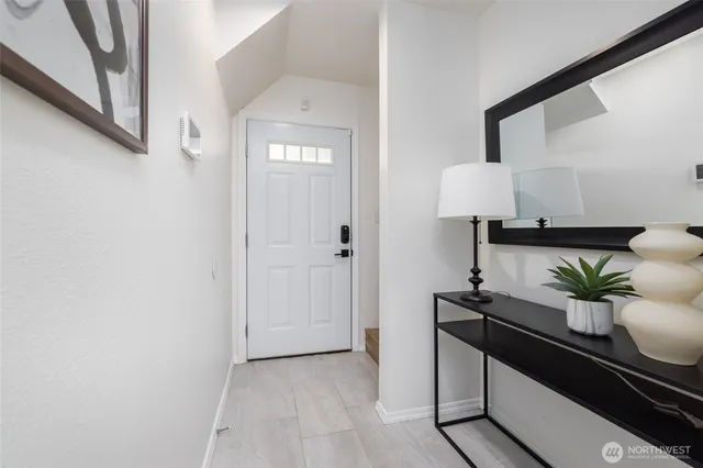 a living room with furniture and a lamp