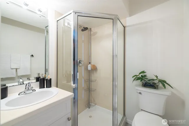 a bathroom with a toilet a sink and shower