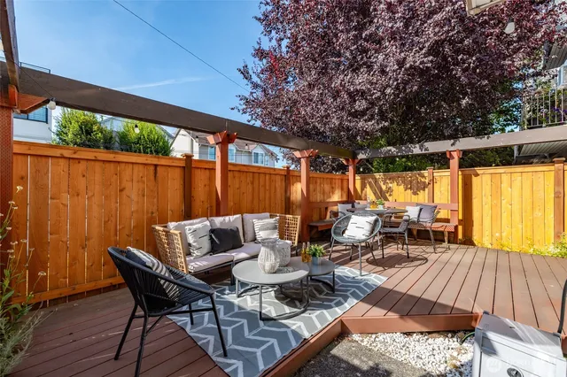 an outdoor living area with furniture and wooden floor